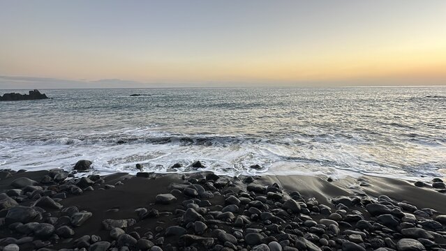sunset on the rocky beach sea waves
