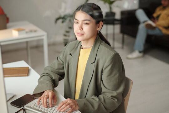 Gen Z Woman Working on Desktop Computer in Office