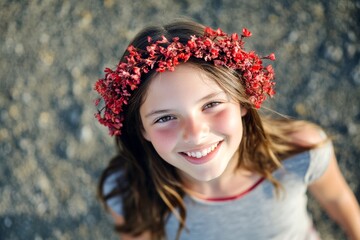 Naklejka premium Morning rays. Happy caucasian teenager girl with brown hair wearing red flower circlet on her head. Happy vacation time concept art. White dress and floral charm. Playful summer vibes for girls.