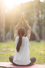 A enthusiastic Asian sports woman stopped after exercising at the garden, sitting on a exercise...