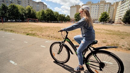 Young student enjoying cycling in a city park, promoting healthy lifestyle and outdoor activities for children