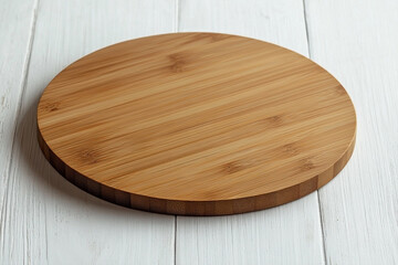 A round bamboo cutting board on a white wood surface for food preparation or presentation