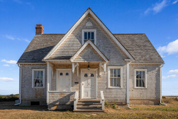 historic Cape Cod dwelling with distinctive roof pitch and entry details