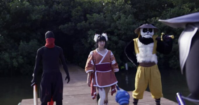Ground of ninjas in fantasy costumes meeting their master on tropical dock then leaping into action