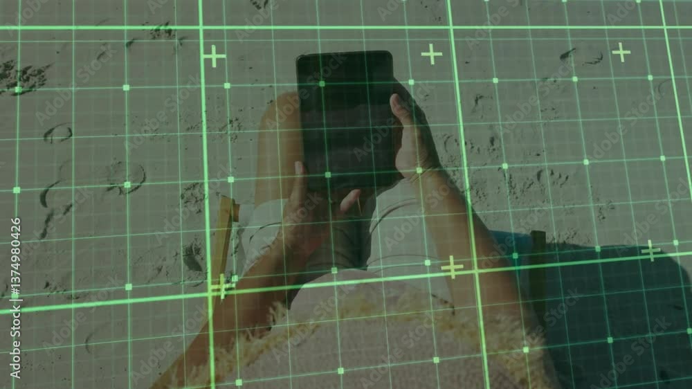 Poster person using tablet on beach with digital grid overlay animation