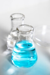 Clear bottles and dishes are used in scientific and medical experiments.