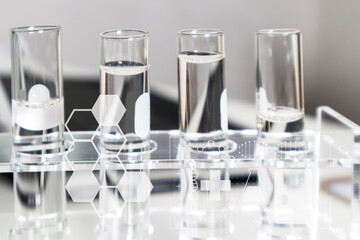Clear bottles and dishes are used in scientific and medical experiments.
