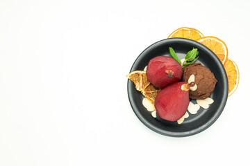 Ice cream and pears in wine on plate and orange slices on white background, space for text