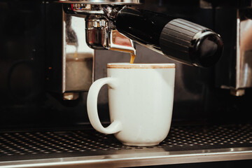 photo of preparation of espresso coffee in an espresso machine in a Colombian coffee shop
