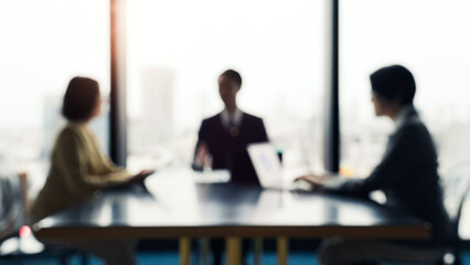 Blurred image of a group of business people having a meeting in an office