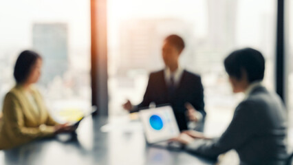 Blurred image of a group of business people having a meeting in an office