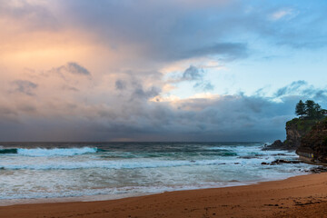 Moody sunrise with waves at the seaside