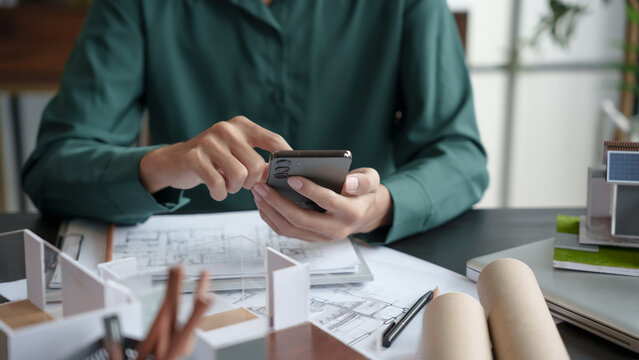 Architecture Man use smart phone for architectural Creative project business architecture ecosystem building construction Industrial engineering Design.