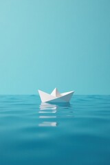 A solitary origami boat floats serenely on a calm, turquoise sea, reflecting the tranquil sky above.