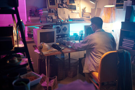 Hacker Writing Code on Old Computer