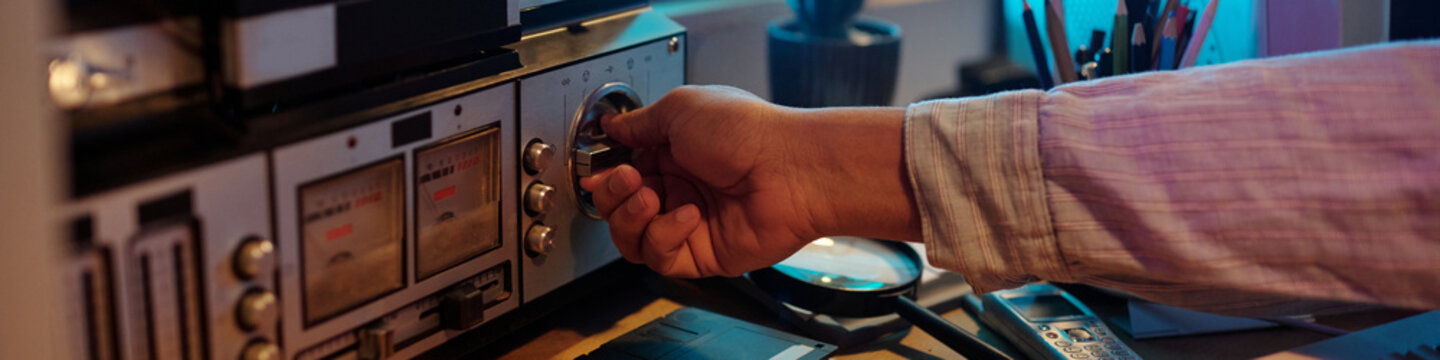 Unrecognizable Man Turning on Vintage Reel-to-Reel Audio Tape Recorder
