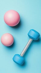 Pink weights and dumbbell on blue background; fitness, health