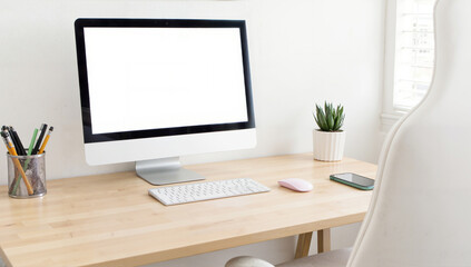 Minimalist workspace with a desktop monitor, soft lighting, wooden desk, potted plant, ideal for productivity and creativity. Isolated on white background or PNG