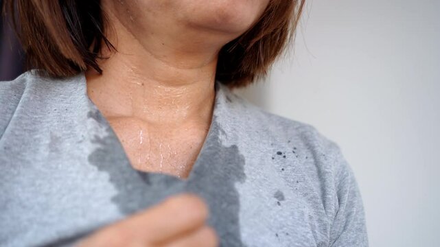 sweating woman feeling extremely tired and overheated during a summer heatwave, breathing quickly and possibly experiencing heatstroke due to high temperatures