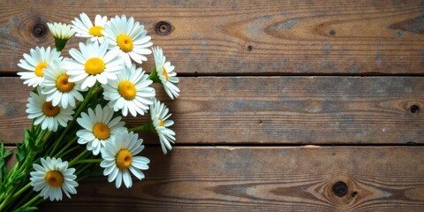 Obraz premium A Delicate Bouquet of Daisies Resting on a Rustic Wooden Surface, a Natural Still Life Composition Perfect for Springtime Greetings or Seasonal Designs
