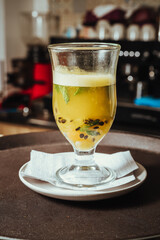 photo of hot aromatic passion fruit and mint with espresso machine in the background at Colombian coffee shop
