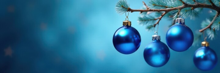 Blue glass ball ornaments hanging from a branch on a blue background, glass, branches