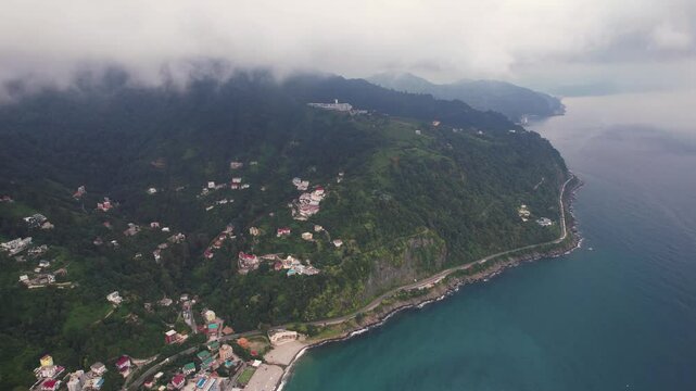 Georgian mountains with sea shore aerial. Caucasus mountains with clouds. Batumi, Georgia, mountains panorama.