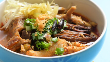 rice vermicelli with northern thai curry sauce on blue background