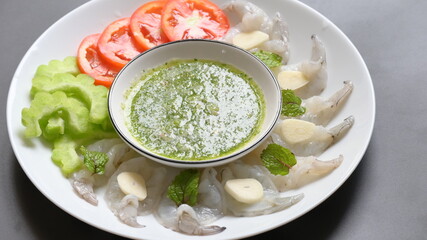 shrimp in fish sauce with Thai spicy seafood dipping sauce on white plate