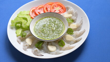 shrimp in fish sauce with Thai spicy seafood dipping sauce on white plate