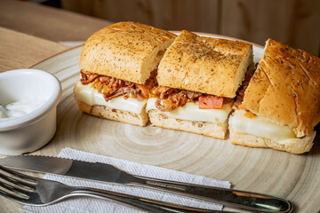 photo of sandwich in three, shredded meat, with ham, caramelized onion and cheese in a Colombian cafeteria