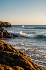 surfers are riding the waves on the rocky shore of the ocean