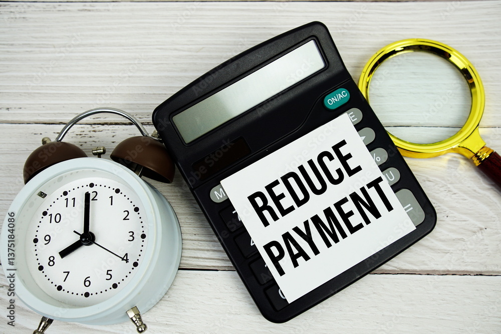 Poster reduce payment text message with calculate, alarm clock and magnifying glass on wooden background