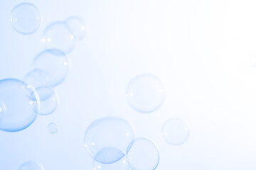 Beautiful Transparent Soap Bubbles Floating in The Air. Freshness Soap Suds Bubbles Water. Celebration Festive Backdrop. Abstract White Gradient and Blue Textured Background.	