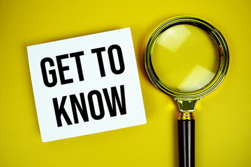 Get to know text on paper card with magnifying glass flat lay on yellow background