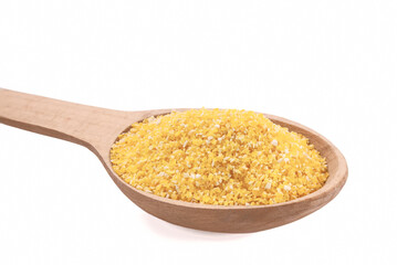 Raw cornmeal in wooden spoon isolated on white.