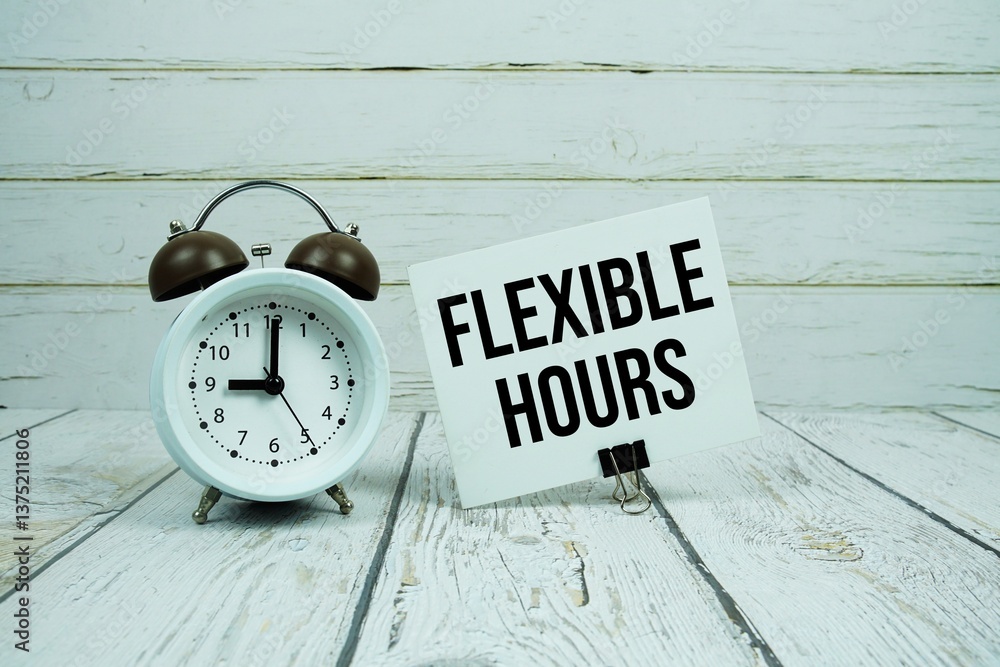 Poster flexible hours text on paper card with alarm clock on wooden background