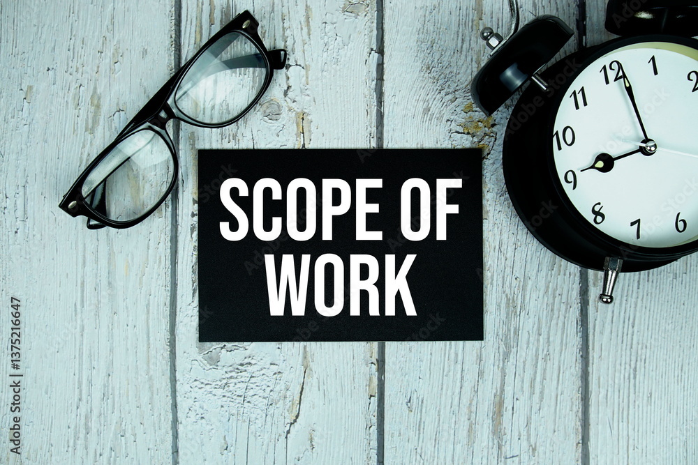 Poster scope of work text on paper card with alarm clock on wooden background