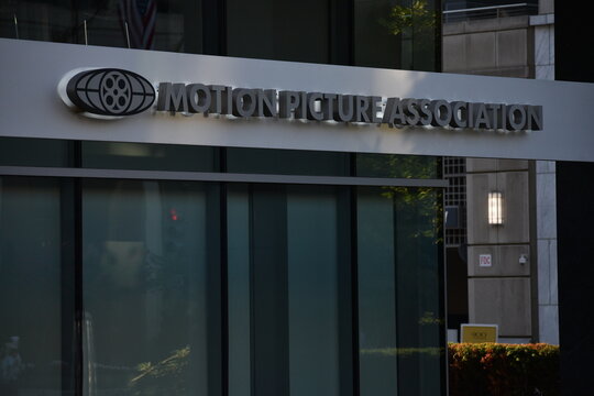 Motion Picture Association of America (MPA) corporate office building entrance with a close-up of the window featuring the official MPA logo