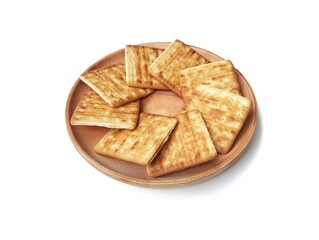 Pile of square cracker biscuit on plate isolated on white background 