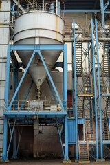 silo coal ash storage at coal-fired powerplant. Industrial hopper and support H beam structure