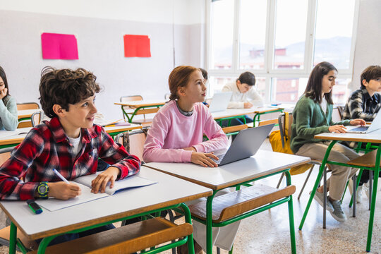 Elementary school students learning and studying in classroom