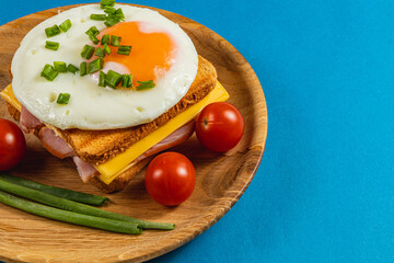 Delicious breakfast sandwich topped with egg and fresh vegetables