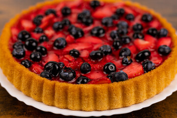 Fresh berry pie on a plate close-up. Berry pie close-up. Homemade cakes