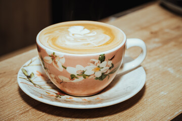 close-up photo of cappuccino with late art (artistic drawing), preparation made with espresso coffee and texturized milk in Colombian coffee shop