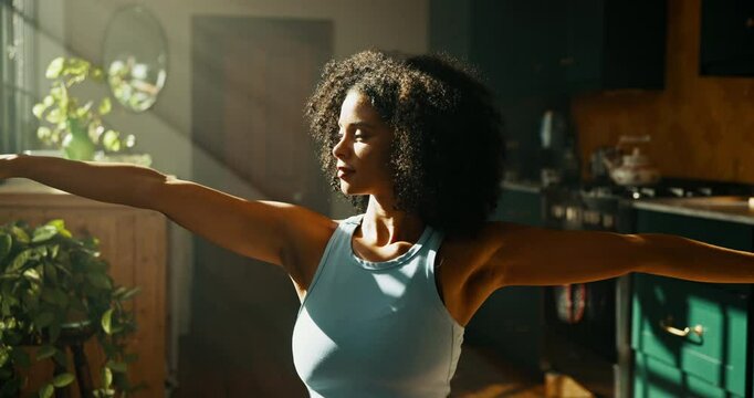 Pilates, woman and stretching in home for fitness, wellness and balance for holistic exercise. Yoga, girl or relax in warrior pose with posture, calm and muscle tension relief with warm up in morning