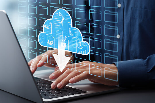 Cloud computing and storage. Remote accessing folders and files in data server. Document management system DMS. Businessman typing on laptop computer keyboard at desk in office. - Powered by Adobe