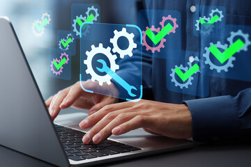Coding and development automation. Automated maintenance and system updates. Engineer using laptop...