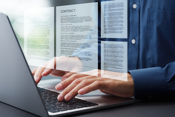Preparing contract agreement or document. Hands typing on laptop computer keyboard. Businessman working at desk in office.