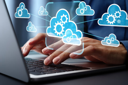 Multi cloud management and orchestration. Cloud interoperability and integration. Engineer using laptop computer to manage and optimize cloud computing systems.
